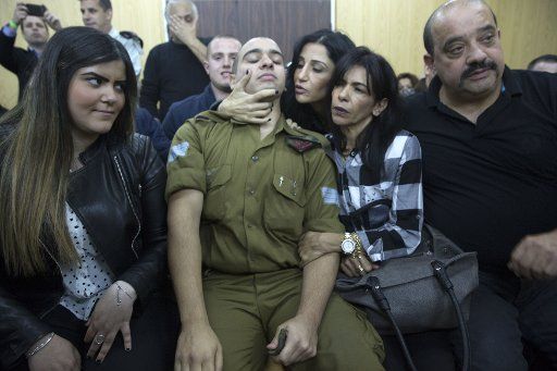 Israeli solider Sgt. Elor Azaria with parents awaits for the verdict inside the military court in Tel Aviv, Israel on January 4, 2017. Azaria was found guilty of manslaughter when he fatally wounded a Palestinian in Hebron. Pool Photo by Heidi Levine \/
