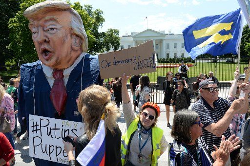Demonstrators protest against President Donald Trump in front of the White House in Washington, DC on May 10, 2017. They were protesting Trump firing FBI Director James Comey who was investigation the Russian influence on the 2016 presidential election. Photo by Pat Benic\/