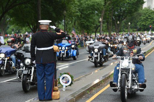 USMC SSgt. Tim Chambers salutes Rolling Thunder riders as participants in the annual Rolling Thunder Ride for Freedom make their way through Washington, D.C., May 28, 2017. Photo by Molly Riley\/