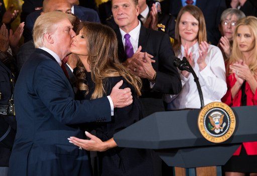 President Donald Trump kisses First Lady Malnia Trump prior to delivering remarks on combatting the opioid crisis, in the East Room at the White House in Washington, D.C. on October 26, 2017. Photo by Kevin Dietsch\/