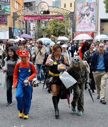 People dress up in their favorite costumes as they participate in a Halloween parade in Kawasaki, Kanagawa-prefecture, Japan, on October 28, 2017. About 1500 kids dressed in costumes take part in the ceremony to celebrate Halloween. Photo by ...