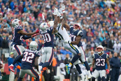 New England Patriots cornerback Malcolm Butler (21), defensive back Duron Harmon (30) and defensive back Jordan Richards (37) break up a pass intended for Los Angeles Chargers wide receiver Mike Williams (81) in the third quarter at Gillette Stadium ...