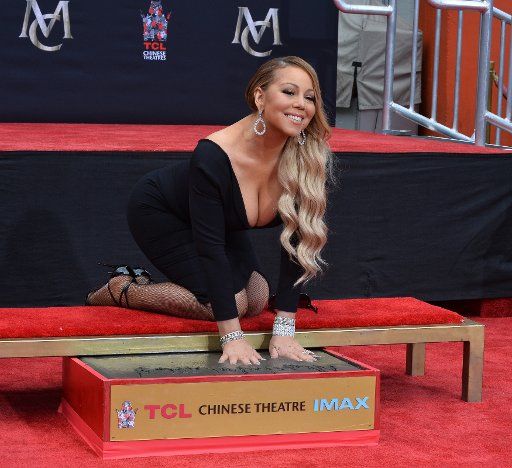 Singer and actor Mariah Carey participates in a hand and footprint ceremony immortalizing her in the forecourt of TCL Chinese Theatre (formerly Grauman\