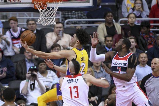 Los Angeles Lakers guard Lonzo Ball (2) scores against Washington Wizards guard John Wall (2) in the first half at Capital One Arena in Washington, D.C. on November 9, 2017. Photo by Mark Goldman\/