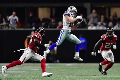 Dallas Cowboys wide receiver Cole Beasley (11) catches the football over Atlanta Falcons defenders Brian Poole (34) and Keanu Neal (22) for a first down during the second half of an NFL game at Mercedes Benz Stadium in Atlanta, November 12, 2017. ...