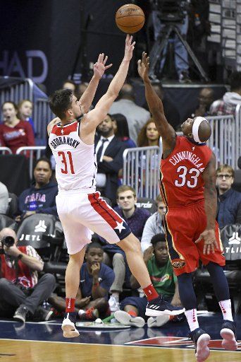 Washington Wizards forward Tomas Satoransky (31) scores against New Orleans Pelicans forward Dante Cunningham (33) in the first half at Capital One Arena in Washington, D.C. on December 19, 2017. Photo by Mark Goldman\/