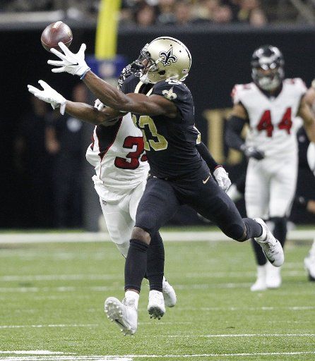 New Orleans Saints wide receiver Michael Thomas (13) snags a drew Brees pass for 27 yards in front of Atlanta Falcons cornerback Brian Poole (34) at the Mercedes-Benz Superdome in New Orleans December 24, 2017. Photo by AJ Sisco\/