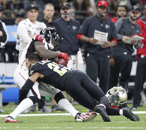 New Orleans Saints cornerback Marshon Lattimore (23) loses his helmet tackling Atlanta Falcons wide receiver Mohamed Sanu (12) picks up 7 yards at the Mercedes-Benz Superdome in New Orleans December 24, 2017. Photo by AJ Sisco\/