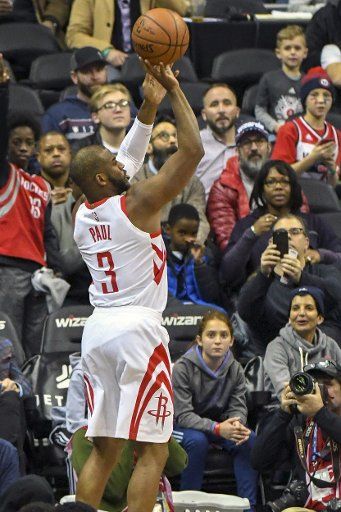 Houston Rockets guard Chris Paul (3) scores a three point basket against the Washington Wizards in the first half at Capital One Arena in Washington, D.C. on December 29, 2017. Photo by Mark Goldman\/