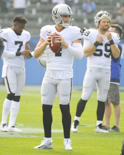 Oakland Raiders quarterback Derek Carr warms up before the game against the Los Angeles Chargers at StuHub Center in Carson, California on December 31, 2017. Photo by Lori Shepler\/