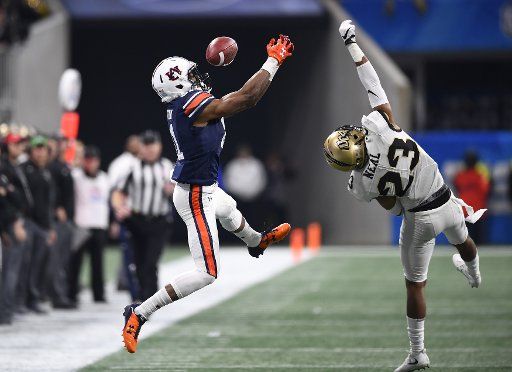 Auburn Tigers wide receiver Darius Slayton (81) misses an intended reception under pressure from University of Central Florida Knights defensive back Tre Neal (23) during the Chick-fil-A Peach Bowl NCAA football game at the Mercedes-Benz Stadium in Atlanta on January 1, 2018. Photo by David Tulis\/