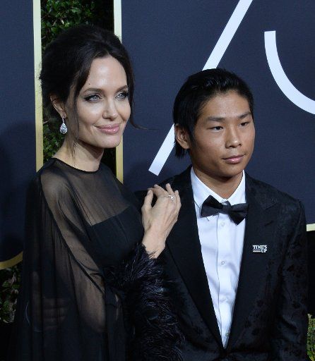 Actor Angelina Jolie (L) and Pax Thien Jolie-Pitt attend the 75th annual Golden Globe Awards at the Beverly Hilton Hotel in Beverly Hills, California on January 7, 2018. Photo by Jim Ruymen\/