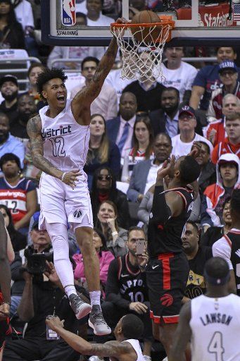 Washington Wizards forward Kelly Oubre Jr. (12) scores on a first half dunk against the Toronto Raptors at Capital One Arena in Washington, D.C. on April 20, 2018 during the first round of the NBA Playoffs. Photo by Mark Goldman\/