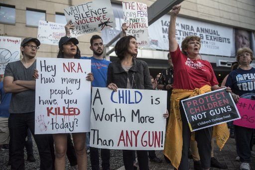 Protesters gather at City Hall across from the NRA Convention at Kay Bailey Hutchison Convention Center in Dallas, Texas on May 4, 2018. Photo by Sergio Flores\/