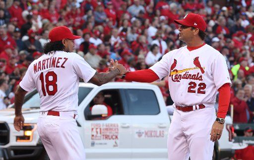 St. Louis Cardinals manager Mike Matheny, welcomes pitcher Carlos Martinez to the field during introductions on Opening Day before a game against the Arizona Diamondbacks at Busch Stadium in St. Louis on April 5, 2018. Photo by Bill Greenblatt\/