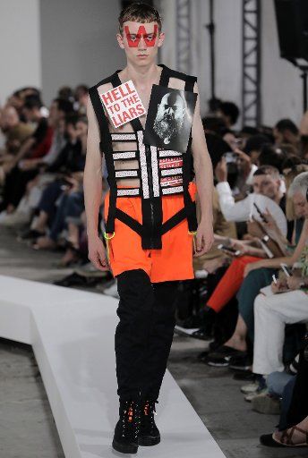 A model takes to the catwalk during the presentation of Walter Van Beirendonck\