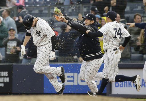 New York Yankees teammates dump sunflower seed on Neil Walker after Walker hits a walk off game winning RBI single in the 11th inning against the Oakland Athletics at Yankee Stadium in New York City on May 12, 2018. The Yankees defeated the Athletics 7-6. Photo by John Angelillo\/
