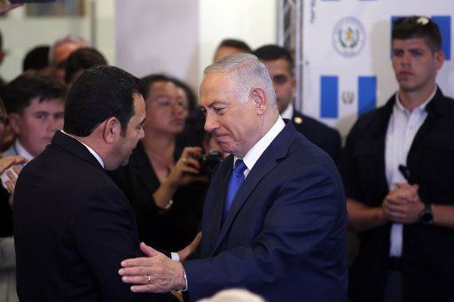 Israeli Prime Minister Benjamin Netanyahu shakes hands with Guatemalan President Jimmy Morales during the dedication ceremony of the embassy of Guatemala in Jerusalem, May 16, 2018. Pool photo by Ronen Zvulun\/
