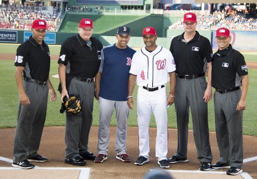 Boston Red Sox manager Alex Cora (center left) and Washington Nationals manager Dave Martinez (center right) pose for a photo with the game umpires prior to their game at Nationals Park in Washington, D.C. on July 2, 2018. Photo by Kevin Dietsch\/