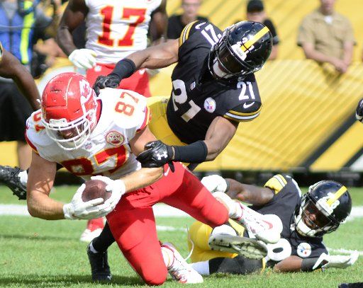 Kansas City Chiefs tight end Travis Kelce (87) reaches for an extra yard and a gain of nine as Pittsburgh Steelers safety Sean Davis (21) makes the tackle during the third quarter of the Chiefs 42-37 win against the Pittsburgh Steelers in Pittsburgh on September 16, 2018. Photo by Archie Carpenter\/