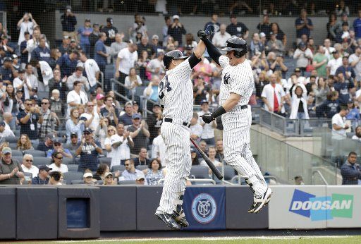 New York Yankees Luke Voit celebrates with Gary Sanchez after he hits a solo home run in the 2nd inning against the Baltimore Orioles at Yankee Stadium in New York City on September 22, 2018. Photo by John Angelillo\/