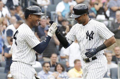 New York Yankees Aaron Hicks celebrates with Miguel Andujar after hitting a solo home run in the 2nd inning against the Baltimore Orioles at Yankee Stadium in New York City on September 22, 2018. Photo by John Angelillo\/
