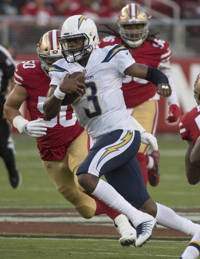 Los Angeles Chargers QB Geno Smith (3) scrambles for a first down in the first quarter against the San Francisco 49ers at Levi\