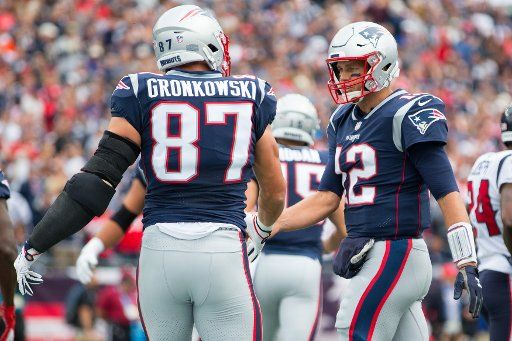 New England Patriots tight end Rob Gronkowski (87) is congratulated by quarterback Tom Brady (12) after the two connected on a touchdown reception in the first quarter against the Houston Texans at Gillette Stadium in Foxborough, Massachusetts on September 9, 2018. The Patriots defeated the Texans 27-20. Photo by Matthew Healey\/