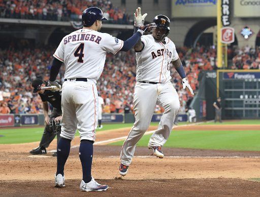 Houston Astros catcher Martin Maldonado (R) celebrates his solo home run with team George Springer during the seventh inning against the Cleveland Indians in American League Divisional Series game one at Minute Maid Park on October 5, 2018 in Houston. Photo by Trask Smith\/