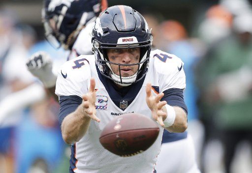 Denver Broncos quarterback Case Keenum tosses the football against the New York Jets at MetLife Stadium in East Rutherford, New Jersey on October 7, 2018. The Jets defeated the Broncos 34-16. Photo by John Angelillo\/