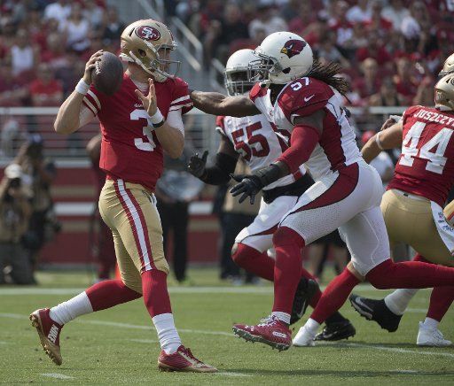 San Francisco 49ers QB C.J. Beathard (3) gets sacked by Arizona Cardinals Josh Byrnes (57) for a loss of 15 yards in the first quarter at Levi\