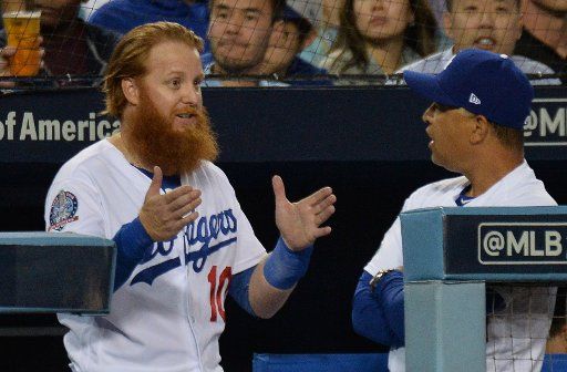 Los Angeles Dodgers third baseman Justin Turner (10) and manager Dave Roberts (R) talk during the sixth inning in game four of the National League Championship Series at Dodger Stadium in Los Angeles, California, October 16, 2018. Photo by Jim Ruymen\/