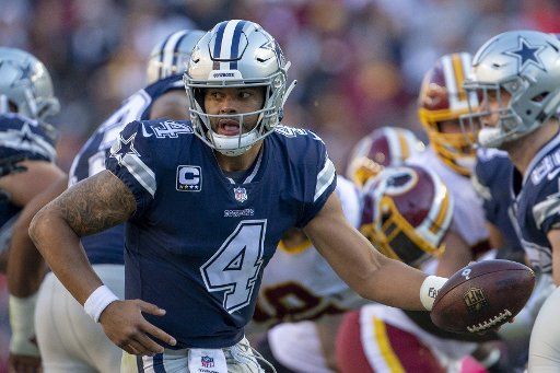 Dallas Cowboys quarterback Dak Prescott (4) hands off the ball during play against the Washington Redskins in the first half of play at FedEx Field in Landover, Maryland on October 21 2018. Photo by Tasos Katopodis\/