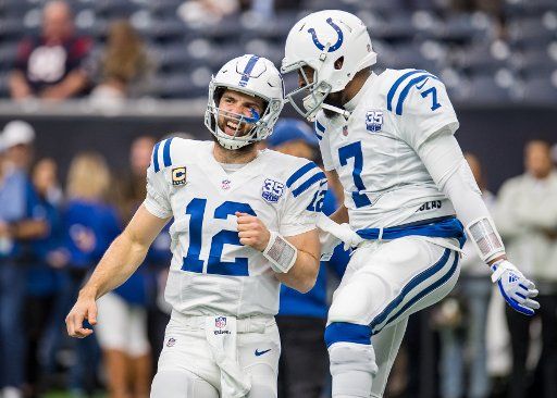 Indianapolis Colts quarterbacks Andrew Luck and Jacoby Brissett smile while entering the field for warmups prior to their Wild Card playoff game against the Houston Texans at NRG Stadium in Houston on January 5, 2019. Photo by Trask Smith\/