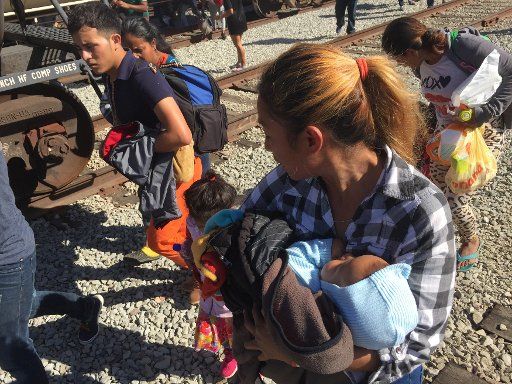 A migrant woman clutches her baby moments before US Customs and Border Protection and Border Patrol fires tear gas and smoke grenades across the border and into Mexico near the San Ysidro Port of Entry on Sunday November 25, 2018. Photo by Patrick Timmons\/UPI...