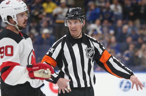 Referee Wes McCauley tries explain a call to New Jersey Devils Marcus Johansson of Sweden in the first period against the St. Louis Blues at the Enterprise Center in St. Louis on February 12, 2019. St. Louis defeated New Jersey 8-3. Photo by Bill Greenblatt\/