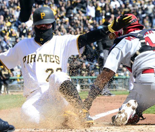 Pittsburgh Pirates catcher Francisco Cervelli (29) is safe at home ahead of the tag of St. Louis Cardinals catcher Yadier Molina (4) in the first inning against the St. Louis Cardinals at PNC Park on April 1, 2019 in Pittsburgh. Photo by Archie Carpenter\/