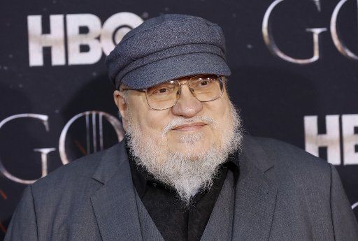 George R.R. Martin arrives on the red carpet at the Season 8 premiere of \