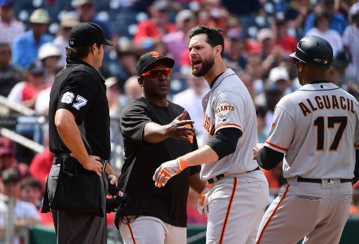 San Francisco Giants first baseman Brandon Belt (9) argues with Umpire Ryan Additon against a called strike in the seventh inning against the Washington Nationals at Nationals Park in Washington, D.C. on April 18, 2019. Photo by Kevin Dietsch\/
