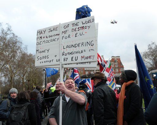 Pro and Anti-Brexit protestors campaign outside the Houses of Parliament ahead of the crucial Brexit vote that will determine the Ukâs Political and Economic future, on March 12, 2019 in London. Photo by Hugo Philpott\/
