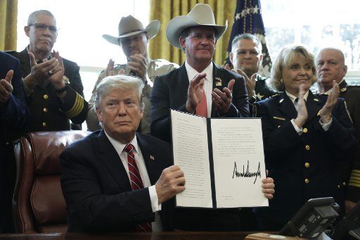 U.S. President Donald Trump signs his first veto if the Congess resolution in the Oval Office of the White House in Washington on March 15, 2019. Photo by Yuri Gripas\/