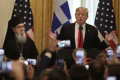 U.S. President Donald Trump delivers remarks next to Orthodox Church Archbishop Demetrios during the Greek Independence Day Celebration at the White House in Washington on March 18, 2019. Photo by Yuri Gripas\/