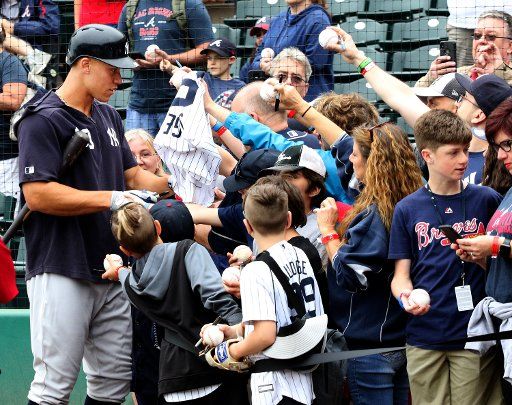 New York Yankees outfielder Aaron Judge signs autographs for fans prior to the game against the Atlanta Braves during a spring training game at Champion Stadium in Kissimmee, Florida on March 18, 2019. Photo by Mark Abraham\/