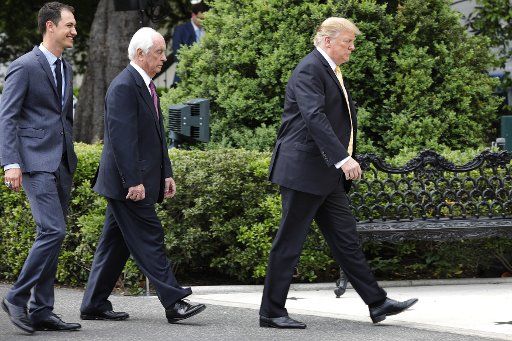 U.S. President Donald Trump (R) arrives with Roger Penske, Founder and Chairman, Penske Corporation; to greet 2018 NASCAR Cup Champion Joey Logano (L) on the South Lawn of the White House in Washington on April 30, 2019. Photo by Yuri Gripas\/