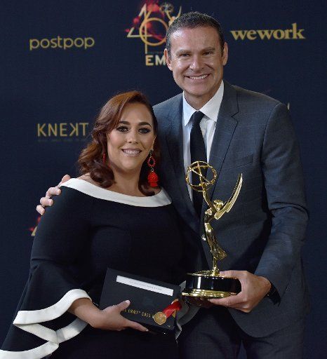 Alan Tacher (R) and Glicia Marquez-Pronesti hold up their Daytime Emmy for Outstanding Morning Program in Spanish for \