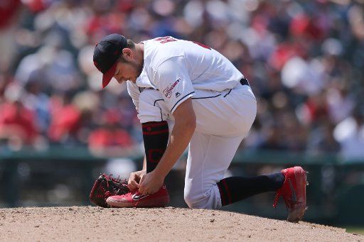 Cleveland Indians Trevor Bauer ties his shoe against the Kansas City Royals in Cleveland, Ohio Wednesday June 26, 2019. Photo by Aaron Josefczyk\/