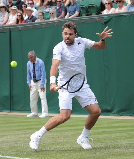 Swiss Stan Wawrinka in action against American Reilly Opelka in the second round match at Wimbledon on Wednesday, July 3, 2019. Photo by Hugo Philpott\/