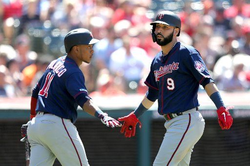 Minnesota Twins Marwin Gonzalez (9) is greeted by Jorge Polanco after scoring in the seventh inning against the Cleveland Indians in Cleveland, Ohio Sunday July 14, 2019. Photo by Aaron Josefczyk\/