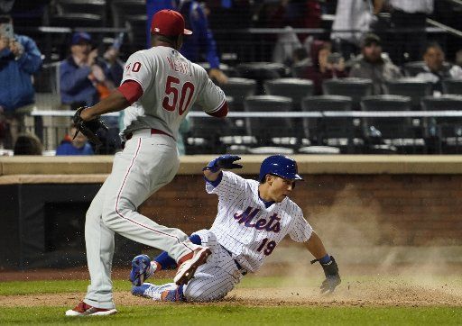 New York Mets runner Sam Haggerty (19) scores as Philadelphia Phillies relief pitcher Hector Neris covers the plate in the eighth inning in their MLB game at Citi Field in New York City on Friday, September 6, 2019. Photo by Ray Stubblebine\/
