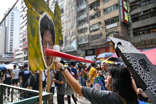 A woman strikes a photo of embattled Hong Kong leader Carrie Lam at a protest in Hong Kong on Sunday, September 15, 2019. Photo by Thomas Maresca\/